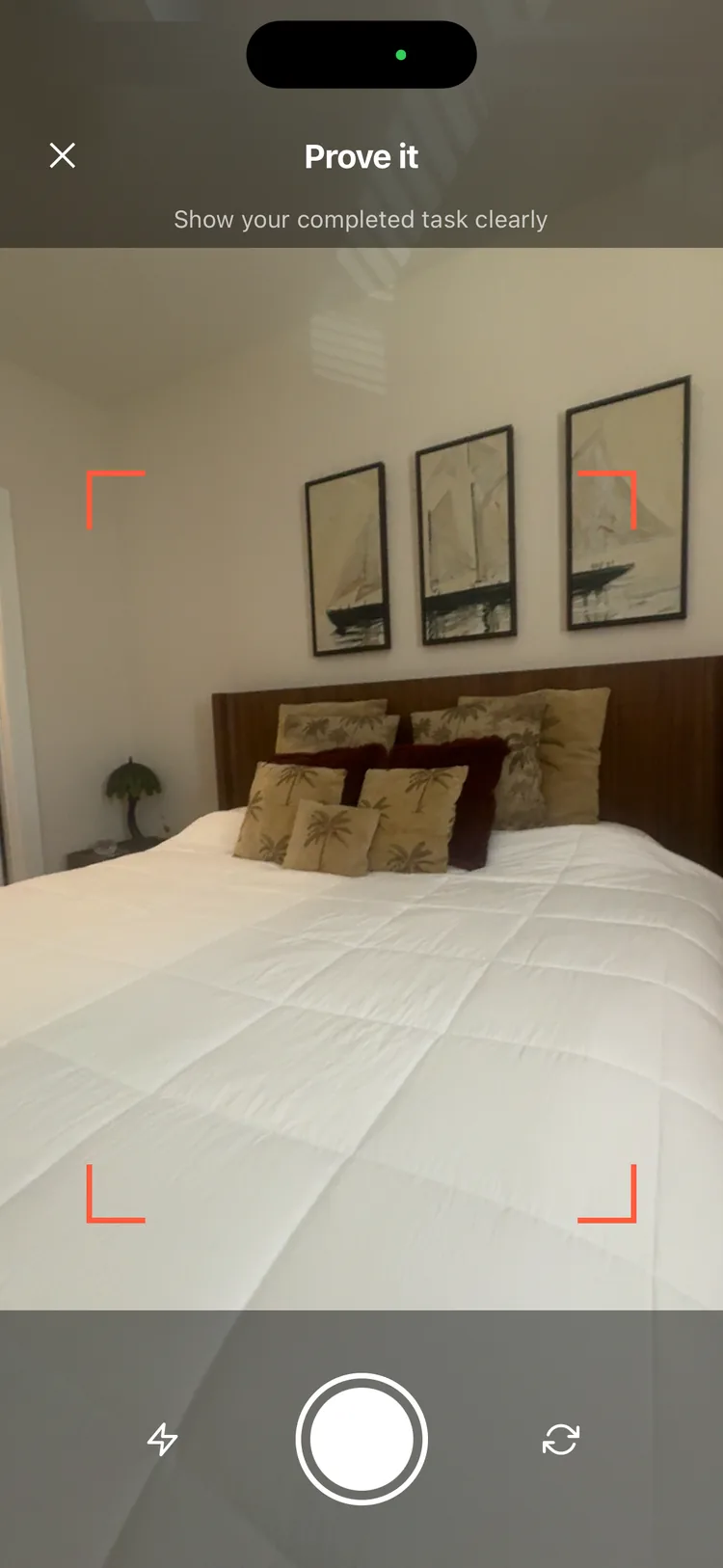 Prove it camera screen — snapping a photo of the made bed as proof